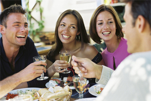 A group of couples enjoying aa restaurant meal. 